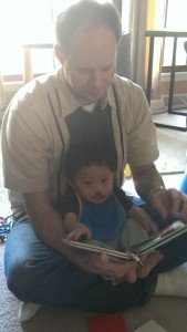 Our little man reading with his dad